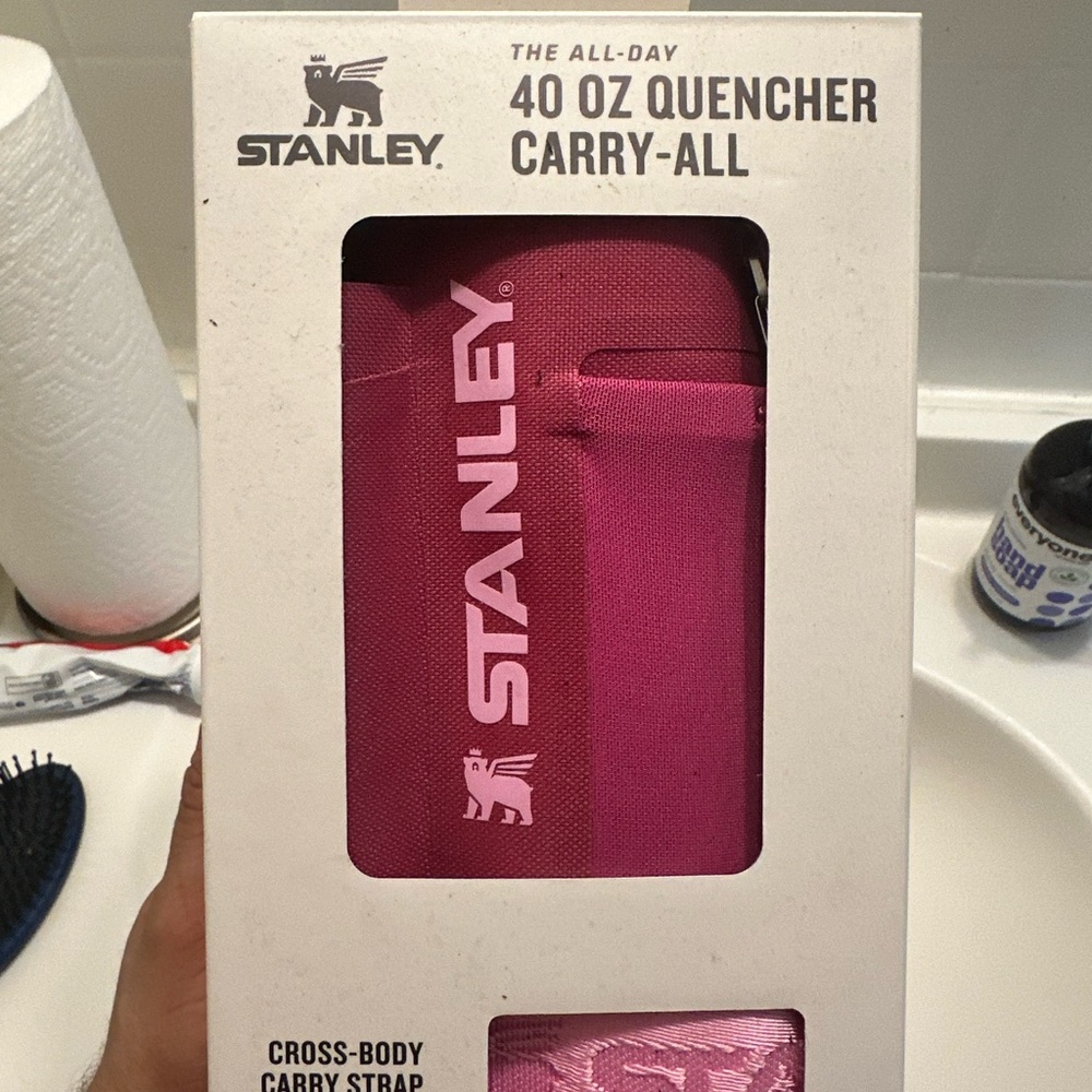 It’s a Stanley pink 40 ounce Crossbody thermos holder